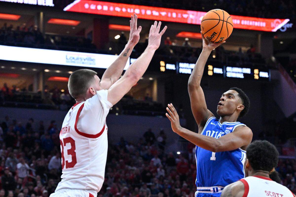 Duke Blue Devils guard Caleb Foster (1) shoots against Louisville Cardinals forward Noah Waterman (93) during the first half at KFC Yum! Center on Dec. 6, 2024.