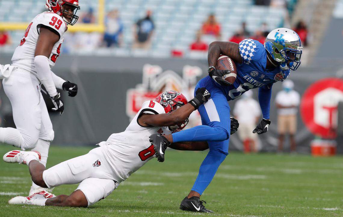 N.C. State safety Jakeen Harris (6) tries to tackle Kentucky wide receiver Josh Ali (6) during the first half of N.C. State’s game against Kentucky in the Gator Bowl at TIAA Bank Field in Jacksonville, Fla., Saturday, January 2, 2021.