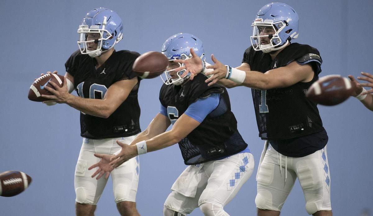North Carolina quarterbacks Jace Ruder (10), Cade Fortin (6) and Sam Howell (7) take snaps during the Tar Heels’ practice on Tuesday, August 6, 2019 at the Football Practice Facility in Chapel Hill, N.C.