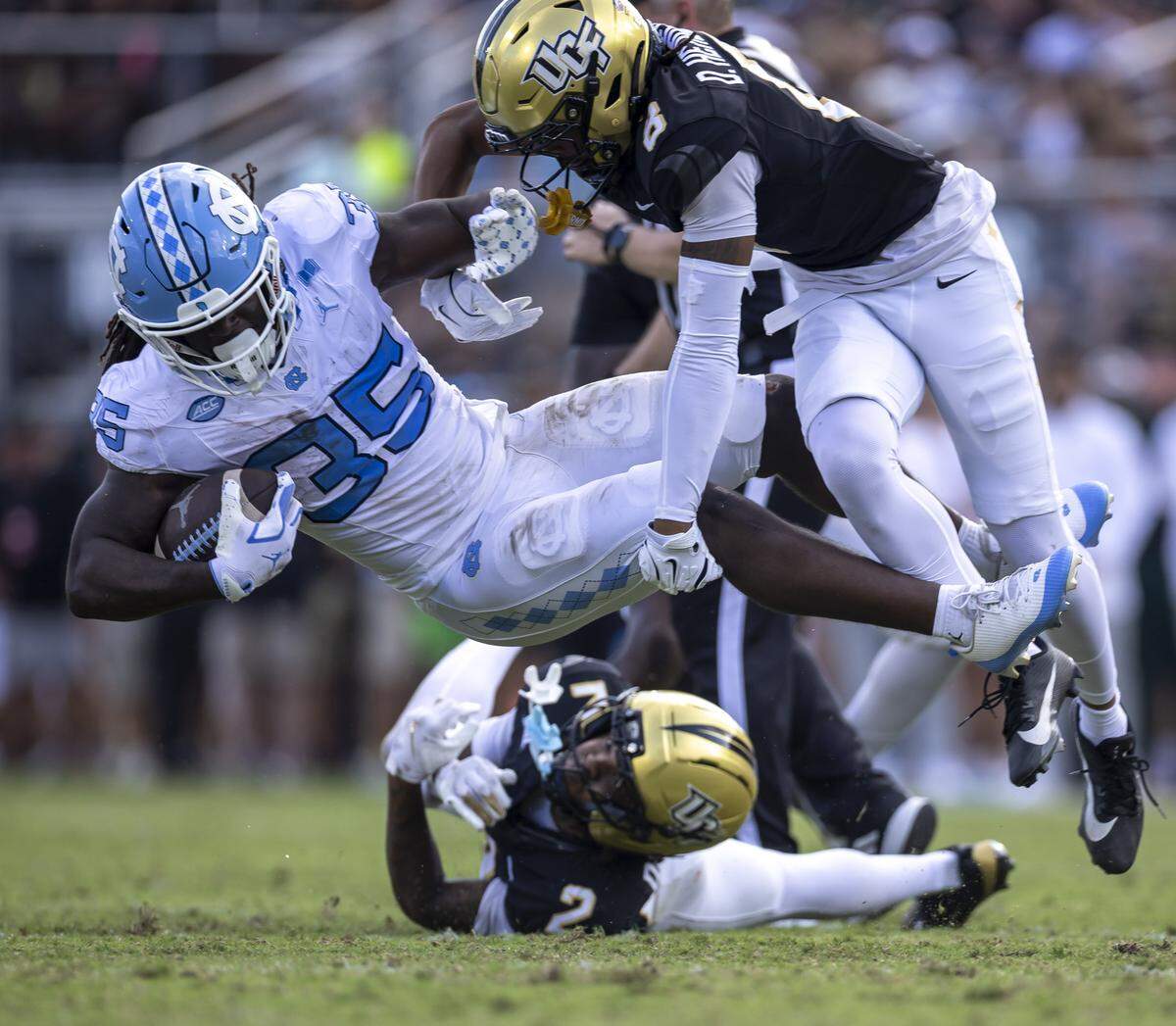 North Carolina running back Demon June (35) is stopped by UCF defensive back Demari Henderson (8) after a 13-yard gain in the second quarter on Saturday, September 20, 2025 at Acrisure Bounce House Stadium in Orlando, Fla.