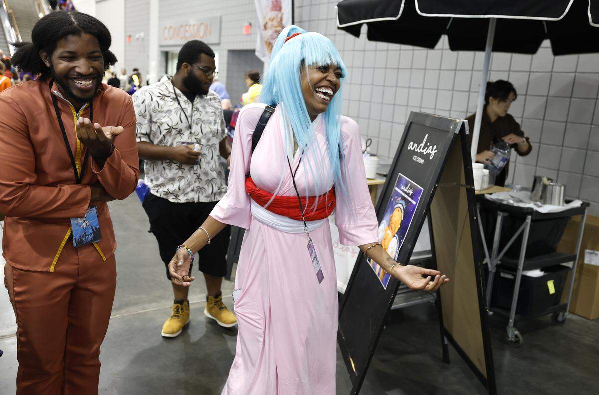 Yasmine Alston, center, of Durham, laughs with friends during GalaxyCon Raleigh at the Raleigh Convention Center Friday, July 25, 2025. Alston is cosplaying Botan from Yu Yu Hakusho.