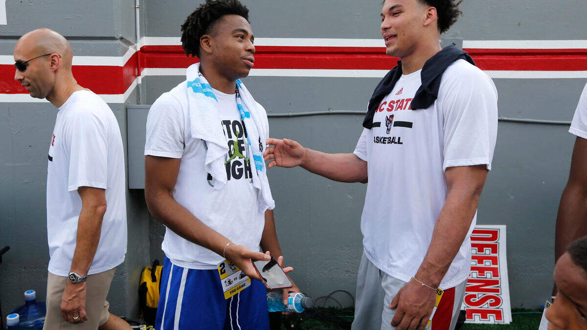 N.C. State target Jalen Lecque talks with Ian Steere before the Wolfpack’s game against Georgia State at Carter-Finley Stadium in Raleigh, N.C., Saturday, Sept. 8, 2018. Lecque, one of the top combo guards in the nation and a 4-star recruit, will make his college announcement on Tuesday.