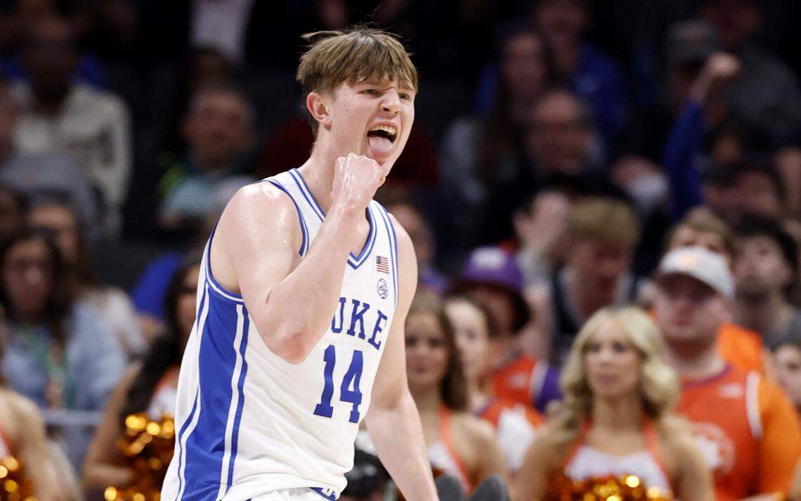 Duke’s Nikolas Khamenia II (14) celebrates after Cayden Boozer made the basket while being fouled during the first half of Duke’s game against Clemson in the semifinals of the 2026 ACC Men’s Basketball Tournament at the Spectrum Center in Charlotte, N.C., Friday, March 13, 2026.