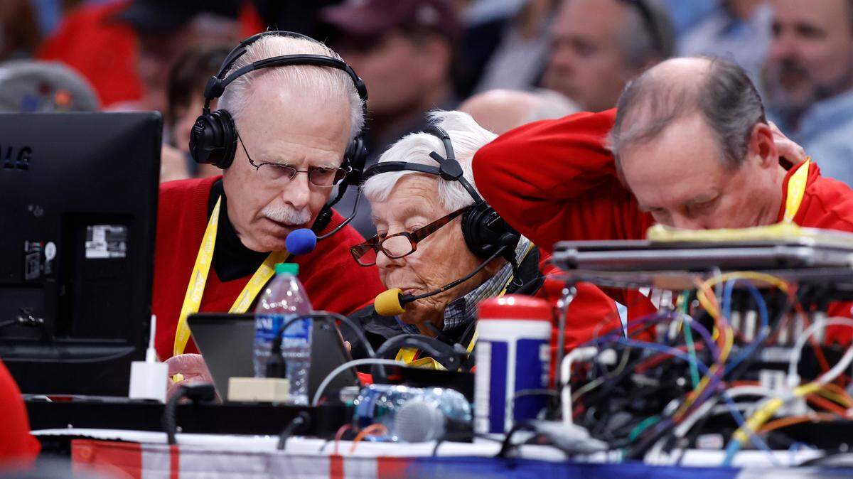 N.C. State radio broadcaster Gary Hahn talks with statistician Howard Baum during the Wolfpack’s 72-65 overtime victory over Virginia in the semifinals of the 2024 ACC Men’s Basketball Tournament at Capital One Arena in Washington, D.C., Friday, March 15, 2024. Color analyst Tony Haynes is to the right.