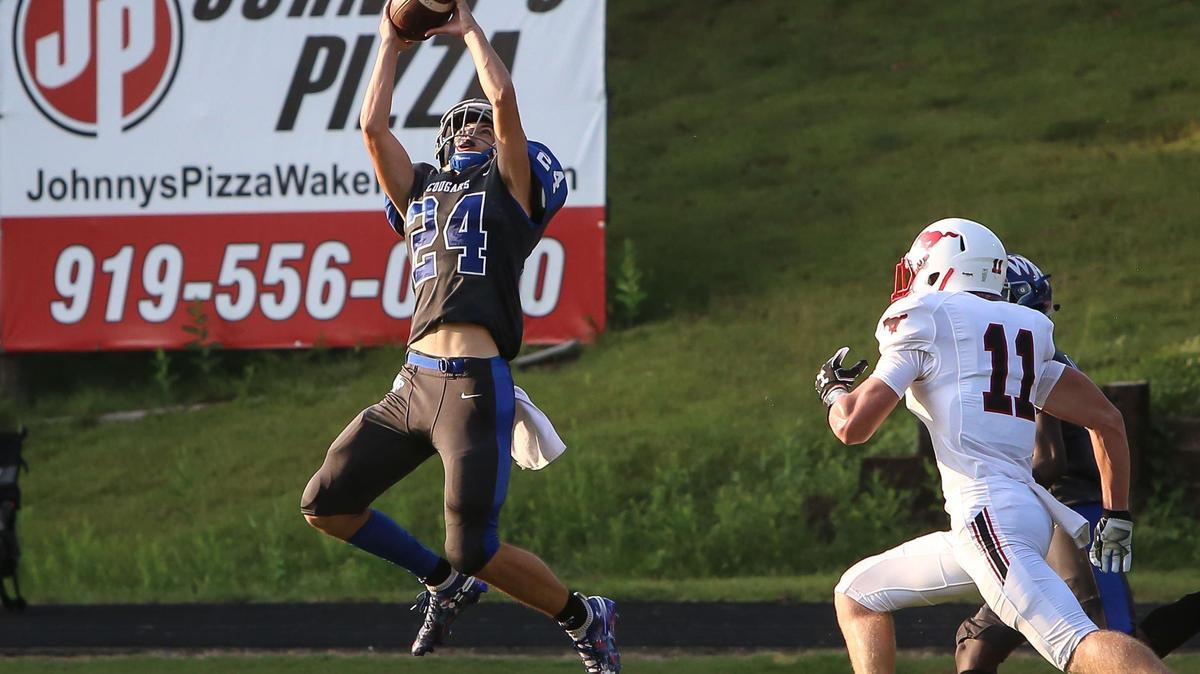 Wake Forest defender Cody Britt (24) intercepts a pass intended for Middle Creek’s Kyle Ihle (11) during the Middle Creek Mustangs’ football game at Wake Forest Cougars on Monday, September 9, 2019.
