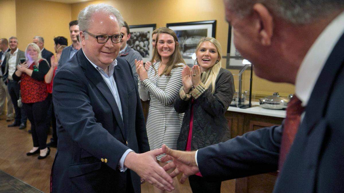 Scott Keller, right, greets Rep. George Holding as he arrives to deliver his victory speech just before midnight on Tuesday, November 6, 2018, at the DoubleTree Hotel in Raleigh, NC. Holding defeated challenger Linda Coleman in the 2nd Congressional district race.