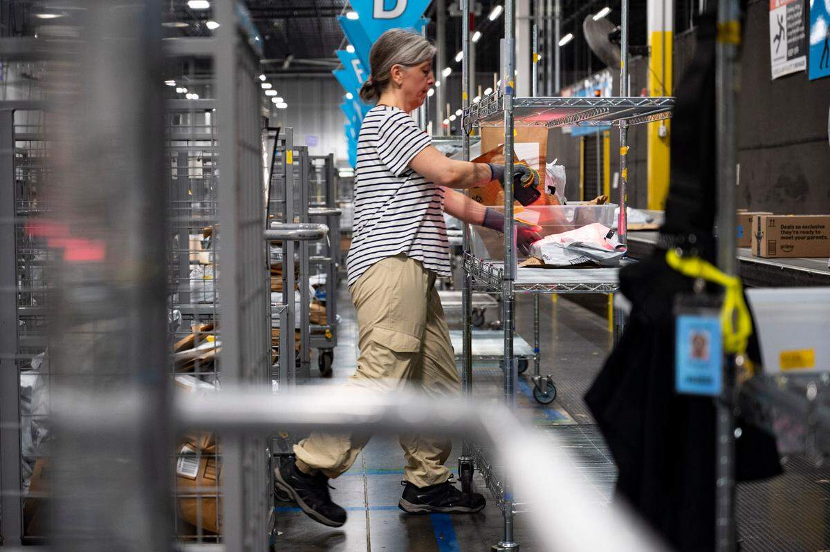 An Amazon worker sorts packages at the Same-Day Delivery Fulfillment Center in Durham on Wednesday July 10, 2024.