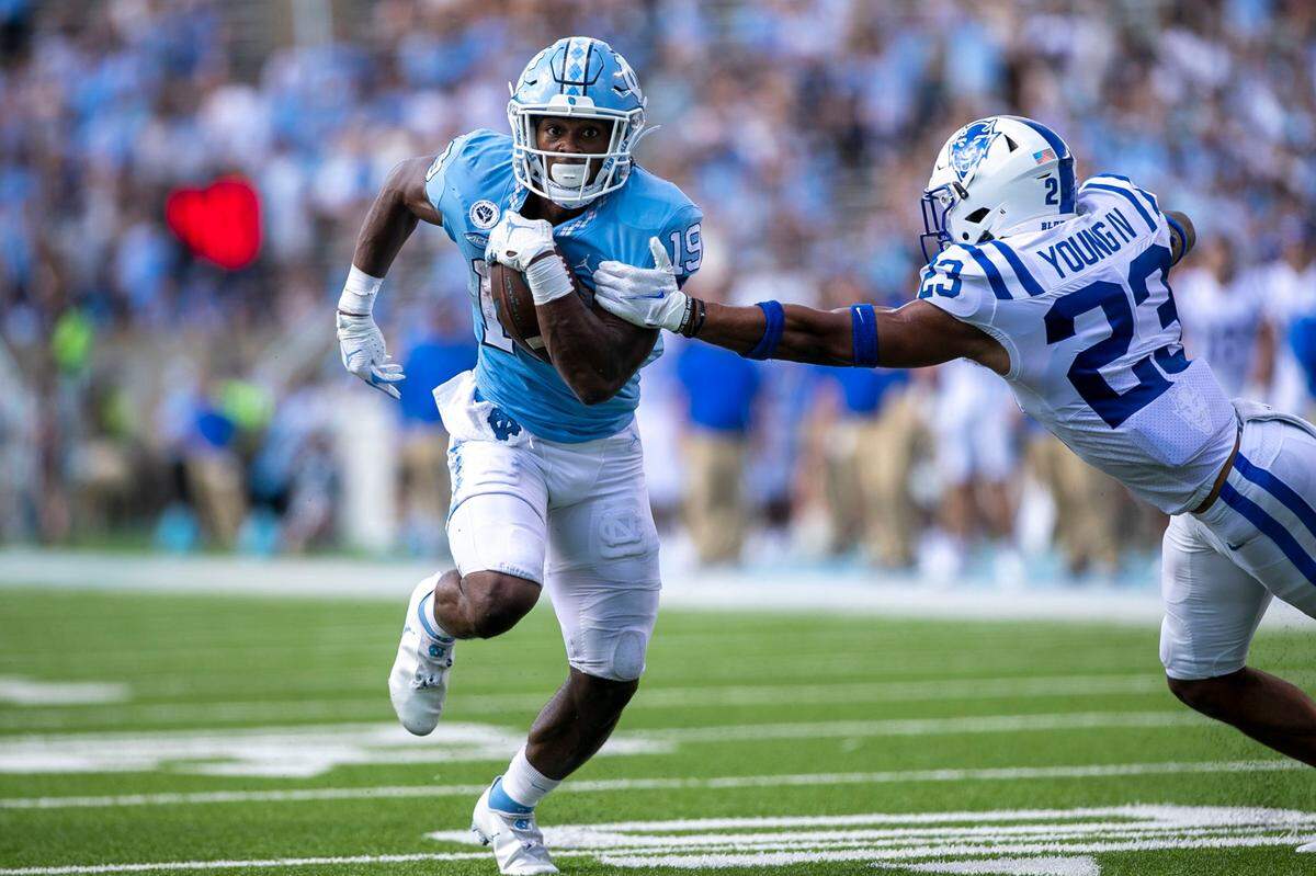 Duke’s Lummie Young IV (23) tries to stop North Carolina’s Ty Chandler (19) on a 14-yard touchdown run in the fourth quarter on Saturday, October 2, 2021 at Kenan Stadium in Chapel Hill, N.C.
