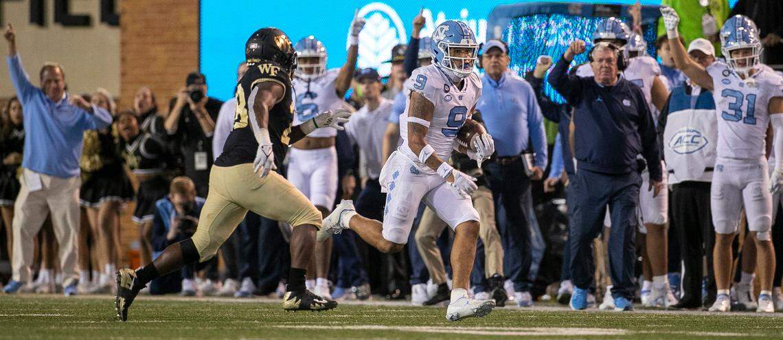 North Carolina’s Cam’Ron Kelly (9) returns an interception of a pass by Wake Forest quarterback Sam Hartman 23-yards in the fourth quarter to set up the game winning field goal on Saturday, November 12, 2022 at Truist Field in Winston-Salem, N.C.