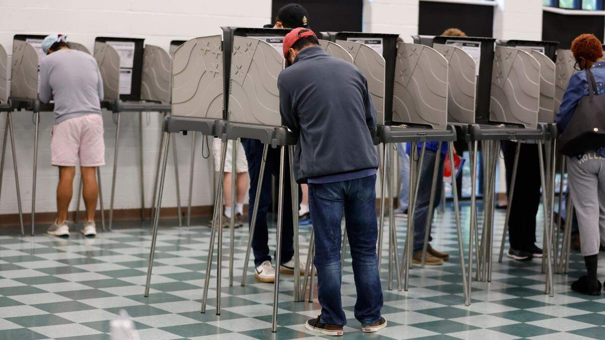 Voters cast their ballot at the early voting site at the Cary Senior Center in Cary, N.C., on Friday, Oct. 28, 2022.