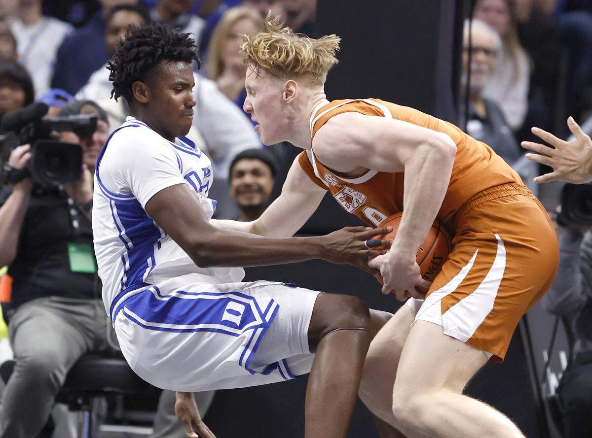 Texas' Matas Vokietaitis (8) charges into Duke’s Patrick Ngongba (21) during the first half of Duke’s game against Texas in the Dick Vitale Invitational at the Spectrum Center in Charlotte, N.C., Tuesday, Nov. 4, 2025.