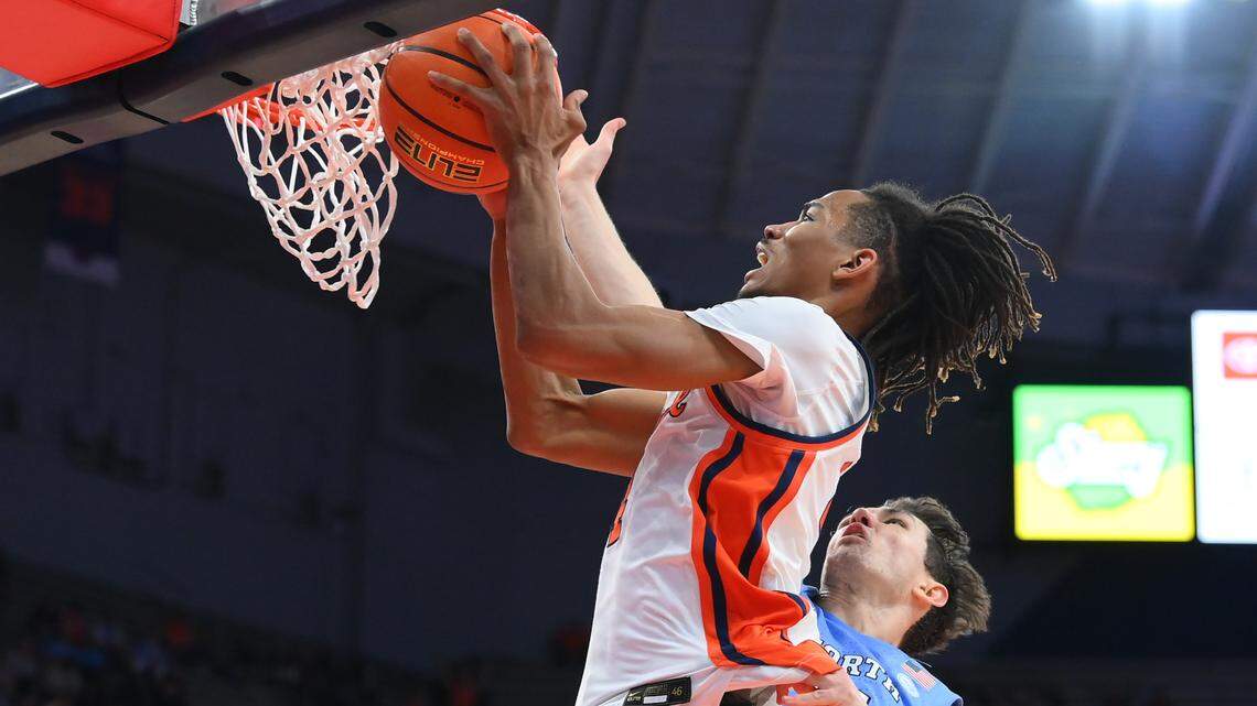 Feb 13, 2024; Syracuse, New York, USA; Syracuse Orange forward Chris Bell (4) drives as North Carolina Tar Heels guard Cormac Ryan (3) defends during the second half at the JMA Wireless Dome. Mandatory Credit: Rich Barnes-USA TODAY Sports