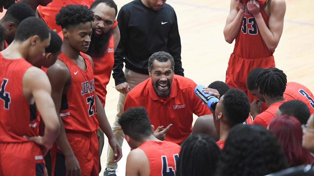 Jordan’s head coach, Rasheed Wallace, center, instructs his team during a timeout. The Jordan Falcons visited the Athens Drive Jaguars in a high school boys basketball game on January 17, 2020.