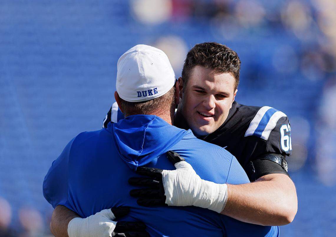 Duke’s Graham Barton hugs head coach Mike Elko during a Senior Day ceremony prior to the Blue Devils’ game against Pittsburgh on Saturday, Nov. 25, 2023, at Wallace Wade Stadium in Durham, N.C.