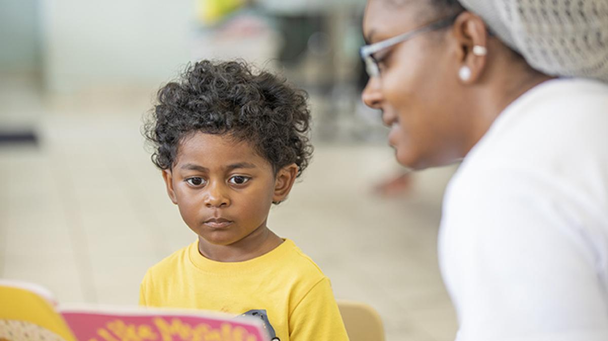 Elias Benitez, 3, left, listens to Nadiah Porter, Community Partnerships Manager for Book Harvest, as she reads to him during a program called ‘Wash & Learn’ which engages children at laundry mats across the country, at The Wash House on Wednesday, Jun. 19, 2019, in Durham, NC.