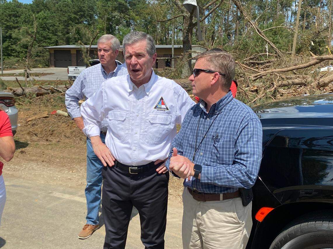Gov. Roy Cooper tours tornado-damaged houses across from Dortches Town Hall with Nash County Emergency Management Director Tony Cameron.