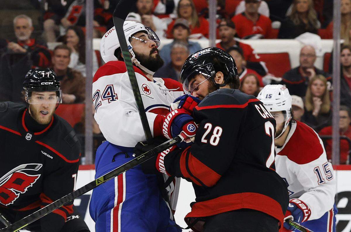 Montréal's Phillip Danault (24) connects with Carolina's William Carrier (28) during the first period of the Hurricanes’ game against the Canadiens in game two of the Eastern Conference Finals at the Lenovo Center in Raleigh, N.C., Saturday, May 23, 2026.