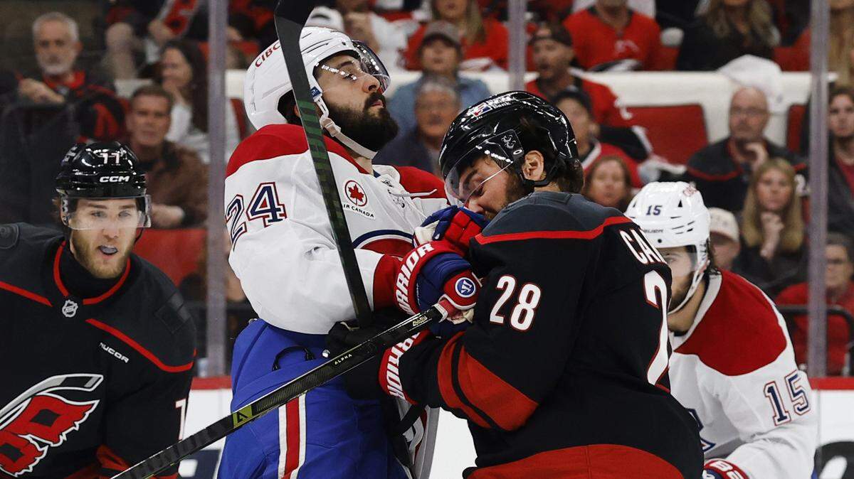 Montréal's Phillip Danault (24) connects with Carolina's William Carrier (28) during the first period of the Hurricanes’ game against the Canadiens in game two of the Eastern Conference Finals at the Lenovo Center in Raleigh, N.C., Saturday, May 23, 2026.