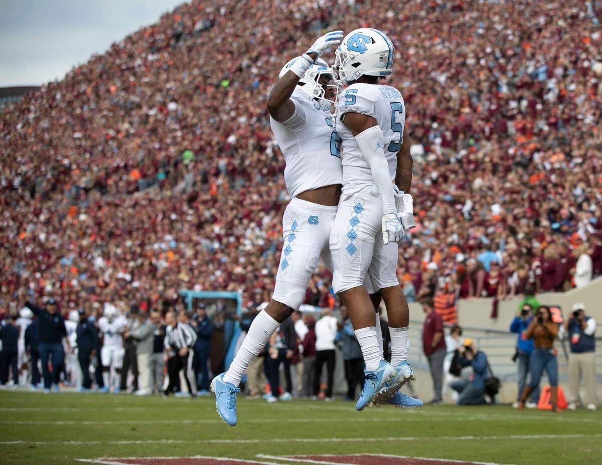 North Carolina’s Dazz Newsome (5) celebrates with Dyami Brown (2) after scoring on a 47-yard reception during their game October 19, 2019 at Lane Stadium in Blacksburg, Va.