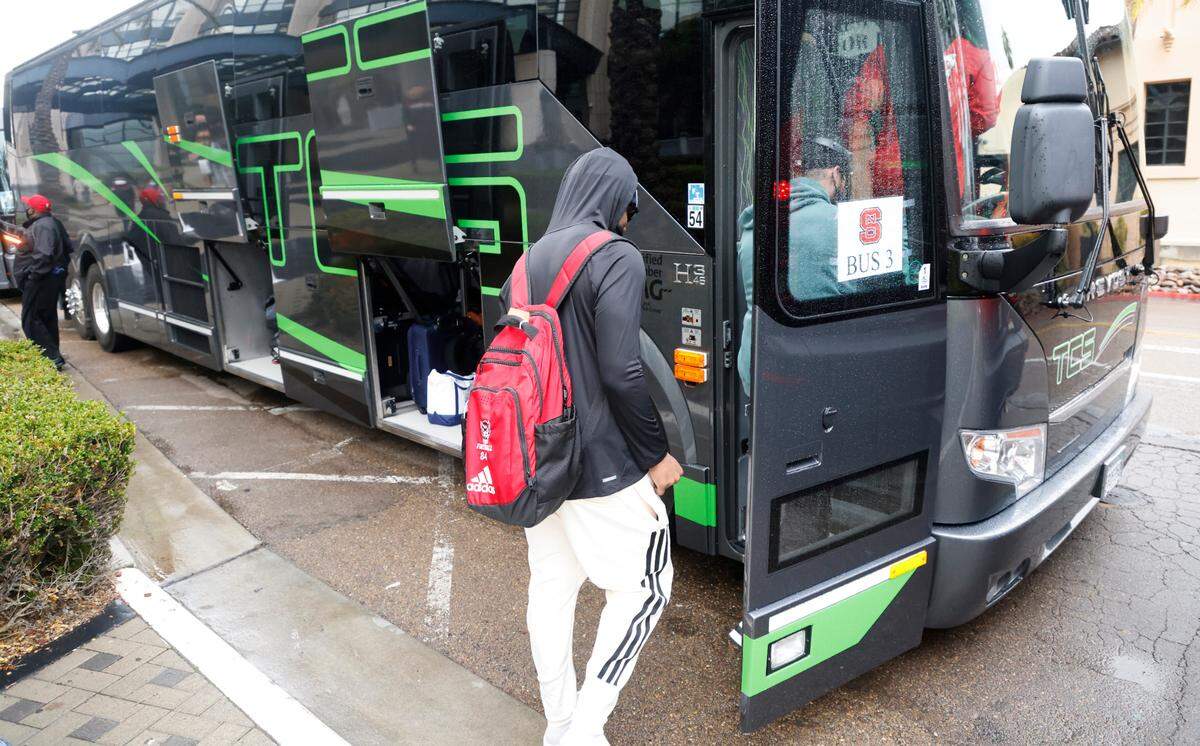 Players get on the team bus as the N.C. State players, coaches and staff leave the team hotel to head to the airport in San Diego, CA Wednesday, Dec. 29, 2021.