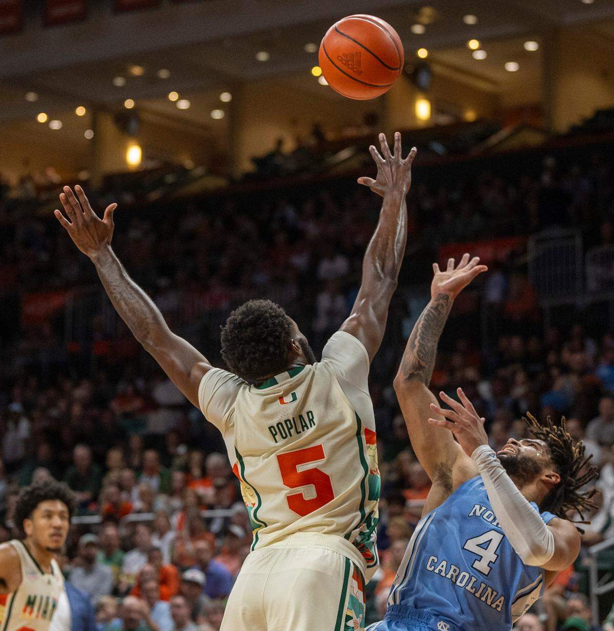 North Carolina’s R.J. Davis (4) puts up a shot over Miami’s Wooga Poplar (5) in the second half on Saturday, February 10, 2024 at the Watsco Center in Coral Gables, Florida. Davis led all scores with 25 points in the Tar Heels’ 75-72 victory.