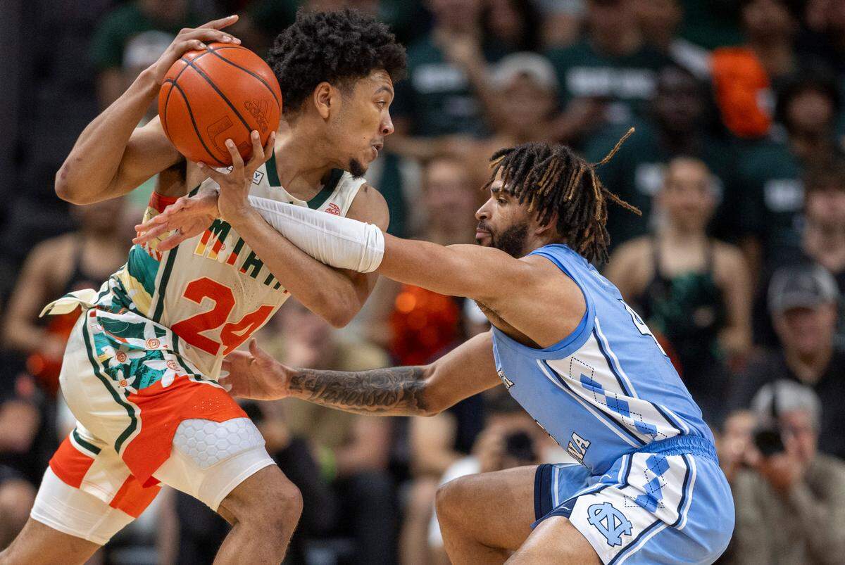 North Carolina’s R.J. Davis (4) defends Miami’s Nijel Pack (24) in the second half on Saturday, February 10, 2024 at the Watsco Center in Coral Gables, Florida.