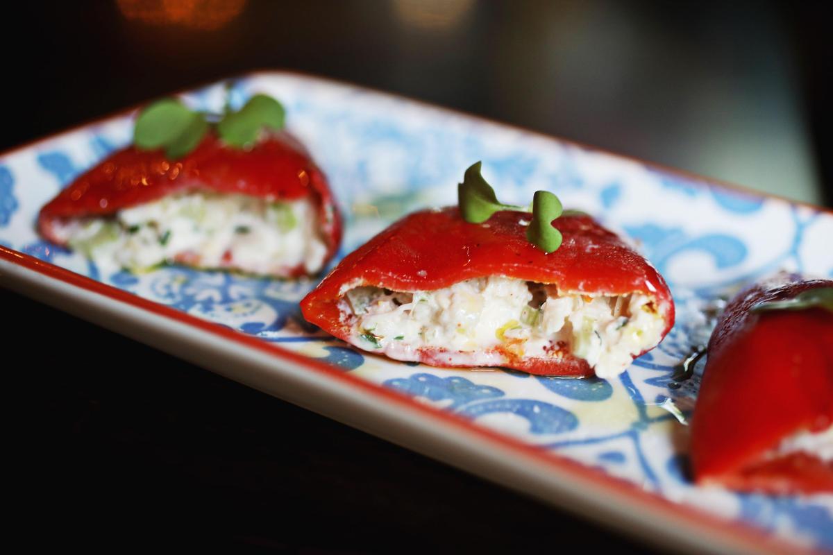 Bodega’s crab-stuffed peppers are a must. The crab, from NC waters, is mostly lump, and it’s folded into a light lemon mayo, then stuffed into sweet, ruby red pouches of piquillo pepper.