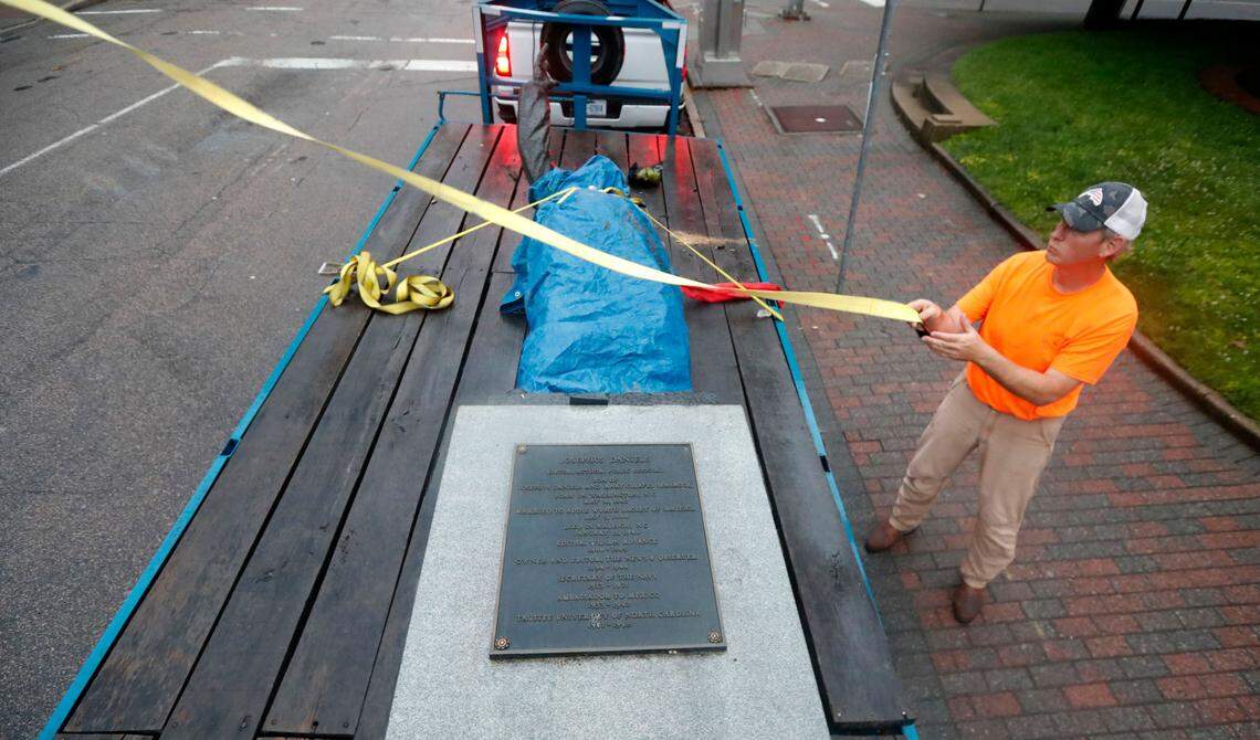 The statue of Josephus Daniels was placed onto a trailer for transport after being removed from Raleigh’s Nash Square early Tuesday morning, June 16, 2020.