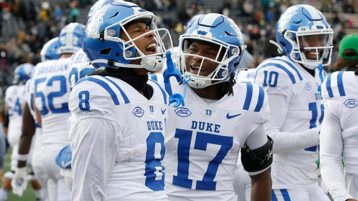 Duke’s Jordan Moore (8) celebrates with teammates after scoring a touchdown as time expired to give the Blue Devils a 23-17 victory over Wake Forest at Allegacy Stadium on Saturday, Nov. 30, 2024, in Winston-Salem, N.C.