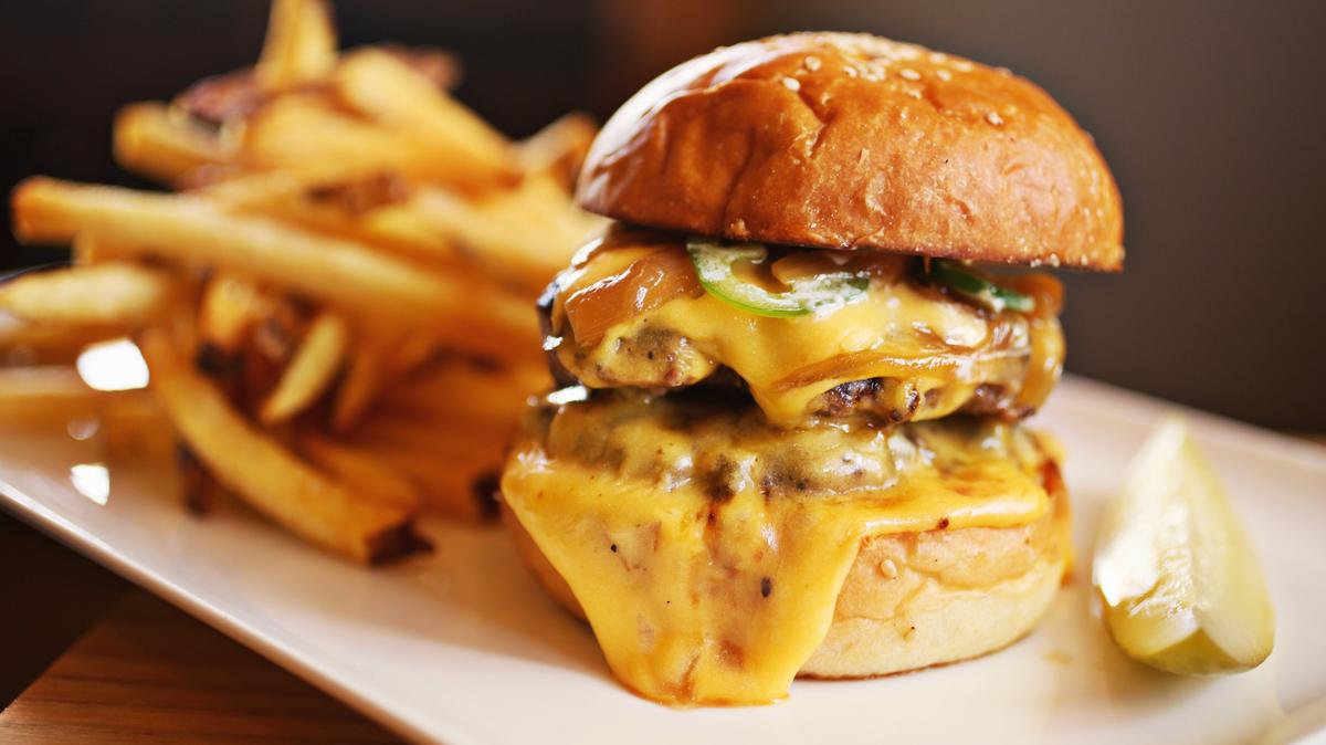 Jack Tar and the Colonel’s Daughter serves a killer double cheeseburger amped up with caramelized onions and jalapeños
on a benne seed bun with a side of fries.