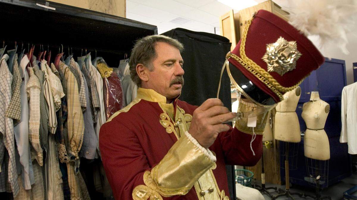 Former “Dukes of Hazzard” star Tom Wopat tries on costumes for his role as Harold Hill in the North Carolina Theatre’s production of “The Music Man” in this file photo from 2012. The theater company has declared bankruptcy and canceled the rest of its 2024 season.