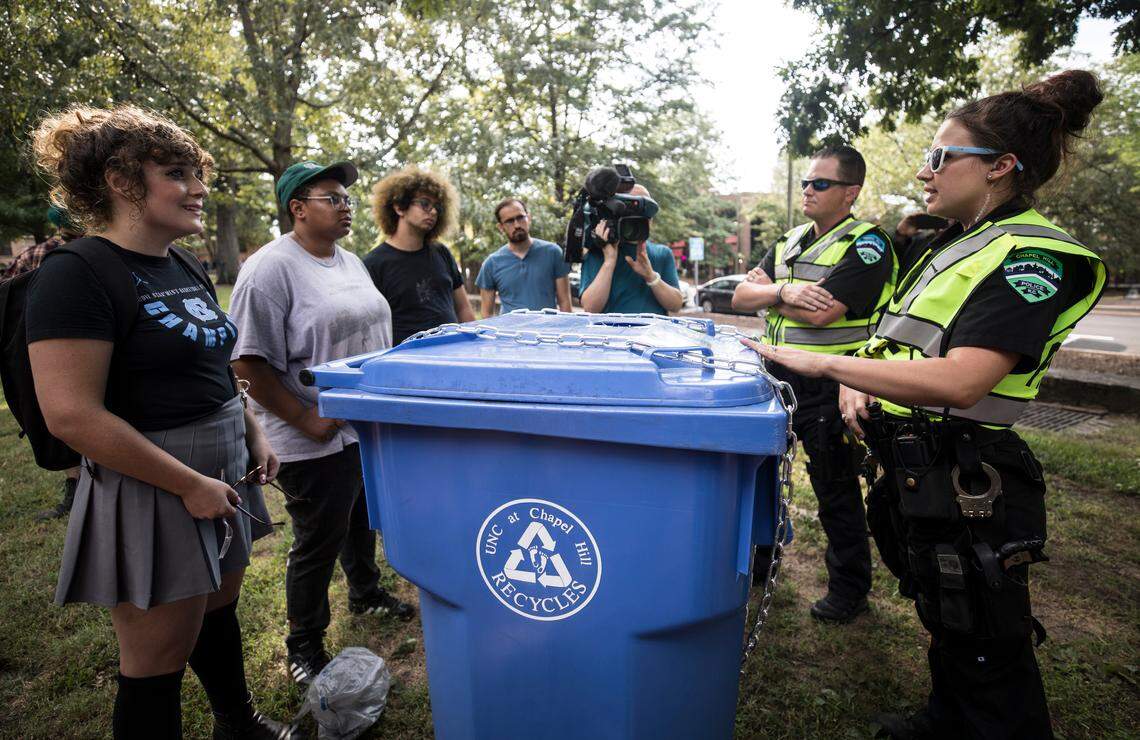 As protesters gathered for a potluck and canned food drive on McCorkle Place on Saturday, September 8, 2018, UNC Police officers confiscated the cans and placed them in a locked recycling bin. They instructed attendees to place their cans in the bins, and said that they would be returned to them at a later time. Protesters confronted the officers to demand answers as to why they had confiscated the canned goods at all. 