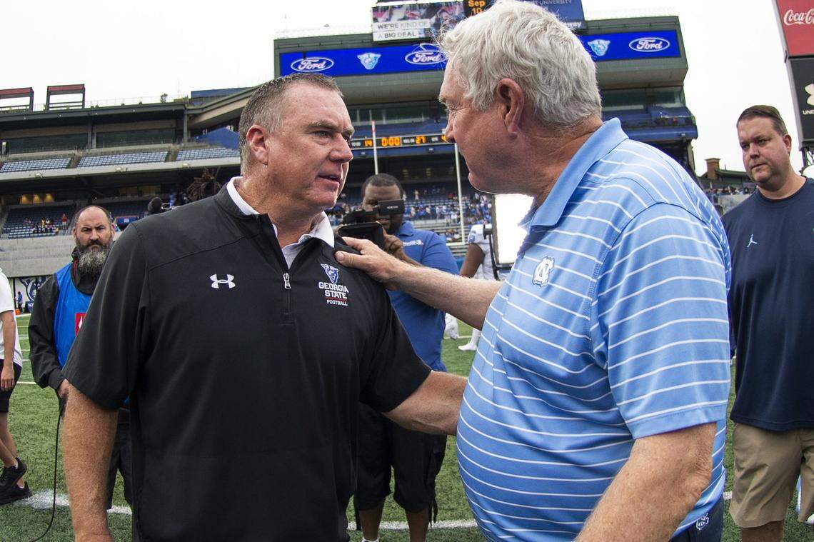 Georgia State head coach Shawn Elliott speaks with North Carolina head coach Mack Brown after a NCAA college football game Saturday, Sept. 10, 2022, in Atlanta.