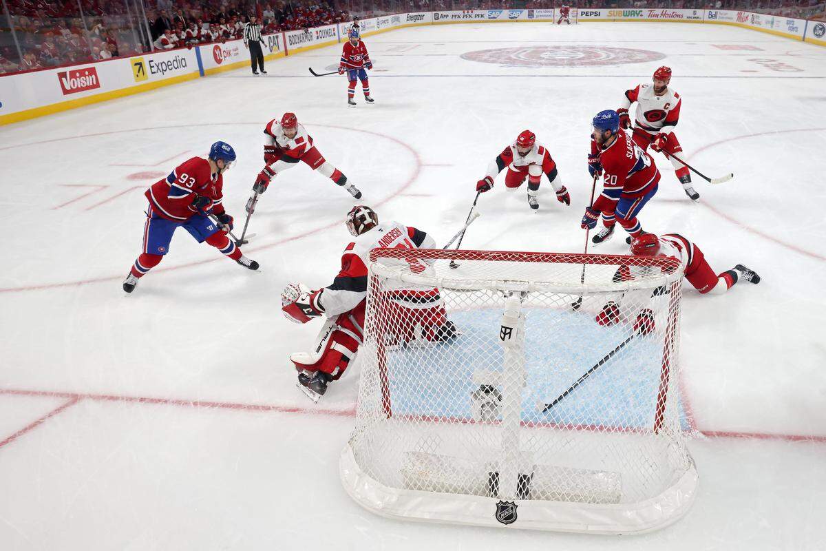 Ivan Demidov #93 of the Montreal Canadiens attempts to shoot the puck against Jaccob Slavin #74 and Frederik Andersen #31 of the Carolina Hurricanes during the first period in Game Four of the Eastern Conference Final of the 2026 Stanley Cup Playoffs at Bell Centre on May 27, 2026 in Montreal, Quebec, Canada. 