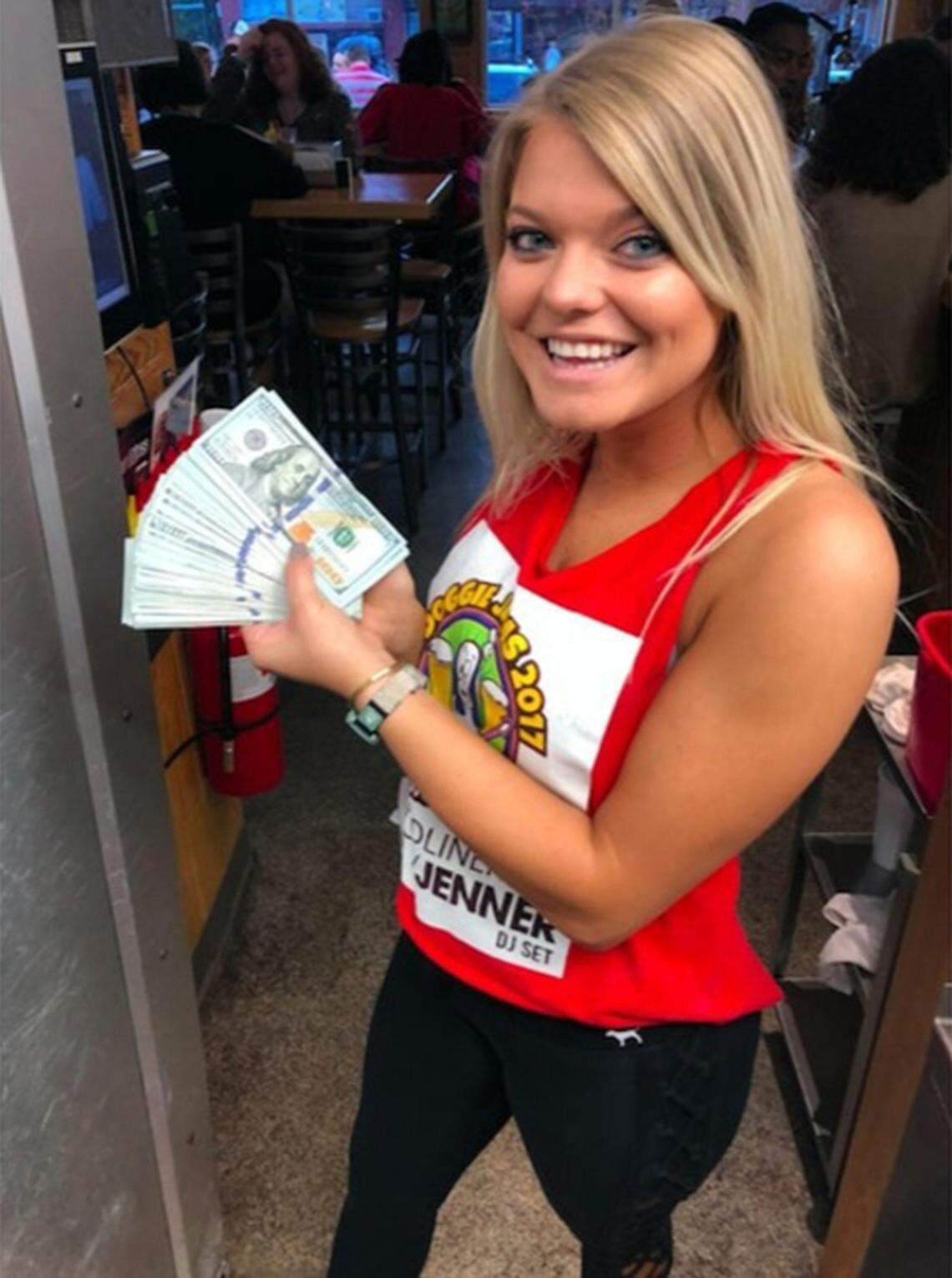 Sup Dogs server and ECU student Alaina poses with the $10,000 cash tip YouTuber Mr. Beast left her on Saturday, Oct. 20, 2018.