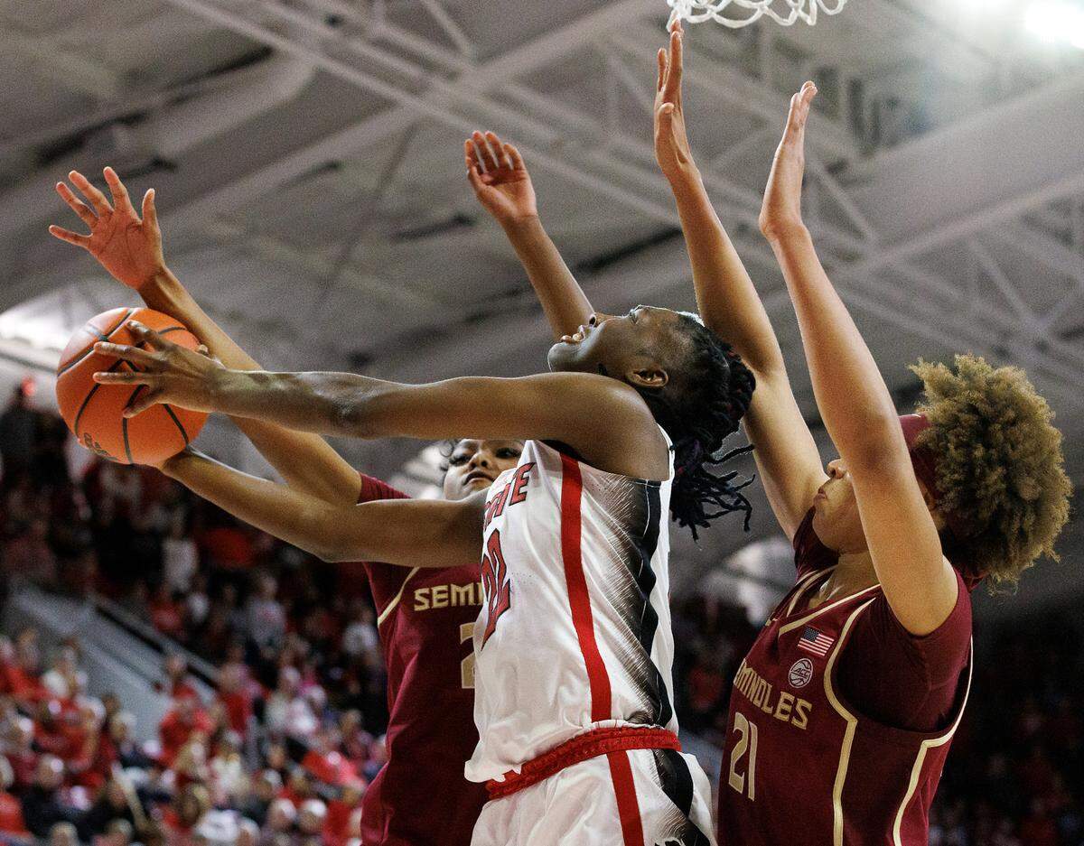 N.C. State’s Saniya Rivers puts up a shot between Florida State’s Amaya Bonner and Makayla Timpson during the second half of the Wolfpack’s 88-80 win on Thursday, Jan. 4, 2023, at Reynolds Coliseum in Raleigh, N.C.