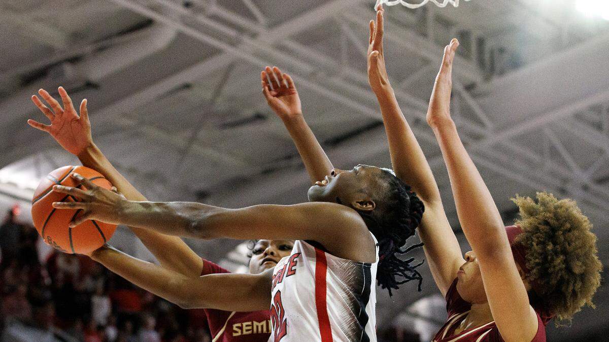 N.C. State’s Saniya Rivers puts up a shot between Florida State’s Amaya Bonner and Makayla Timpson during the second half of the Wolfpack’s 88-80 win on Thursday, Jan. 4, 2023, at Reynolds Coliseum in Raleigh, N.C.
