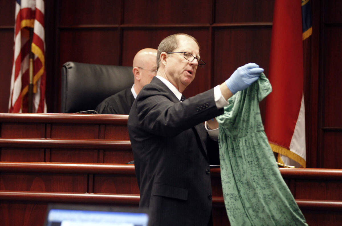 In 2011, Prosecutor Howard Cummings holds up the dress Nancy Cooper was thought to have been wearing the night before she disappeared from her home. Her husband, Brad, has been charged with first-degree murder.