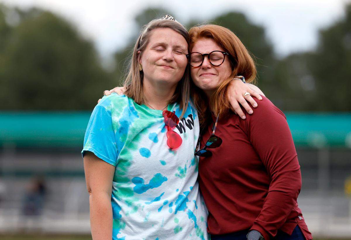 Whitford Wooten, left, hugs her sister Carrington Burton, as Wooten is honored before Ravenscroft High School’s field hockey game against St. Mary’s School Tuesday, Oct. 10, 2023. Wooten, an assistant coach on the team, has ALS (amyotrophic lateral sclerosis or Lou Gehrig’s disease), a progressive neurodegenerative disease.