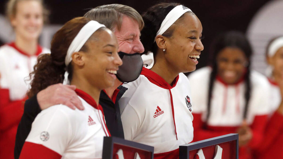 N.C. State head coach Wes Moore poses with seniors Kai Crutchfield, left, and Kayla Jones during senior day activities before N.C. State’s game against Pittsburgh at Reynolds Coliseum in Raleigh, N.C., Thursday, February 25, 2021.