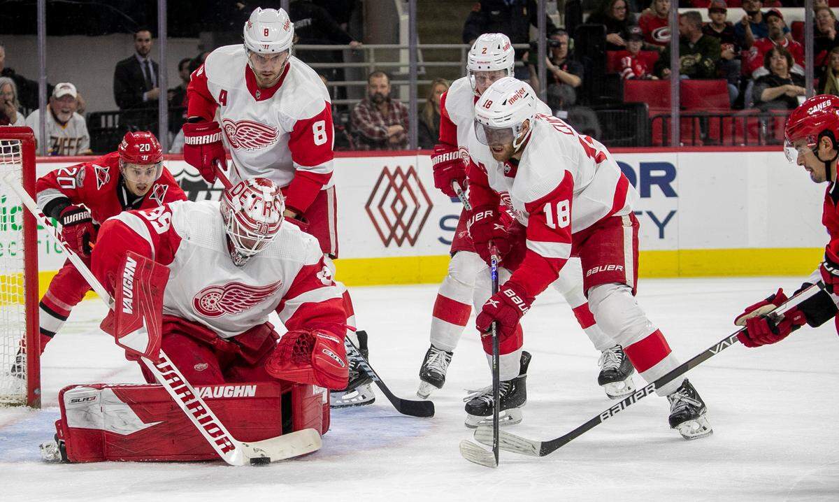 Detroit goalie Alex Nedeljkovic (39) stops a scoring attempt by Carolina’s Hurricanes’ Seth Jarvis (24) during the first period on Tuesday, April 11, 2023 at PNC Arena in Raleigh, N.C.