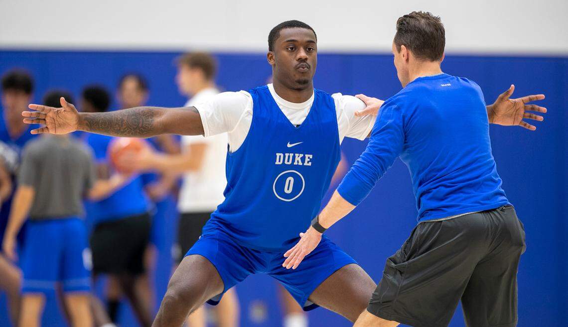 Duke trainer Nick Potter works with freshman Dariq Whitehead (0) during the Blue Devils’ practice on Tuesday, September 27, 2022 in Durham, N.C. Whitehead is recovering from a fractured foot that required surgery in August.