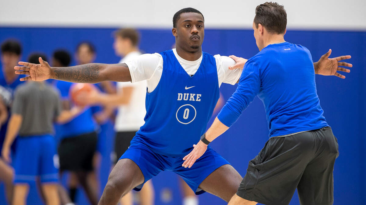 Duke trainer Nick Potter works with freshman Dariq Whitehead (0) during the Blue Devils’ practice on Tuesday, September 27, 2022 in Durham, N.C. Whitehead is recovering from a fractured foot that required surgery in August.