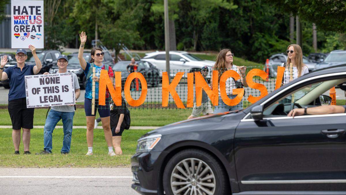 More than 1500 demonstrators lined Capital Boulevard to protest the policies and tactics of the of President Donald Trump on Saturday, June 14, 2025 near Triangle Town Center in Raleigh. The Raleigh “No Kings” rally was one of dozens across North Carolina and hundreds nationwide on what organizers called a nationwide day of defiance against the Trump administration.