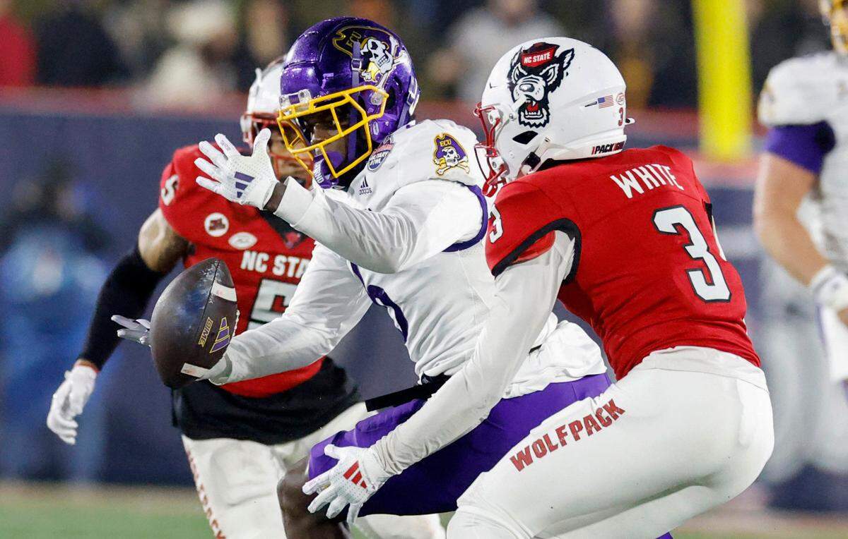 East Carolina tight end Desirrio Riles (6) pulls in the reception while defended by N.C. State cornerback Aydan White (3) during the first half of N.C. State’s game against ECU in the Military Bowl at Navy-Marine Corps Memorial Stadium in Annapolis, Md., Saturday, Dec. 28, 2024.