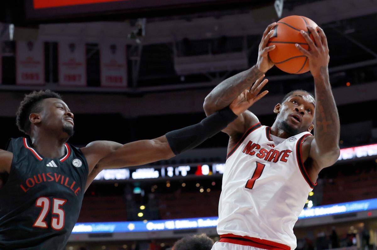 N.C. State’s Brandon Huntley-Hatfield grabs a rebound away from Louisville’s Aboubacar Traore during the first half of the Wolfpack’s 91-66 loss on Wednesday, Feb. 12, 2025, at Lenovo Center in Raleigh, N.C.