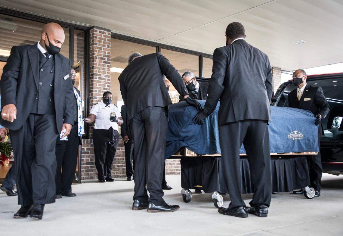 George Floyd’s casket is removed from a hearse outside the entrance to the R.L. Douglas Cape Fear Conference Center for a public viewing and private memorial service on Saturday, June 6, 2020 in Raeford, N.C.