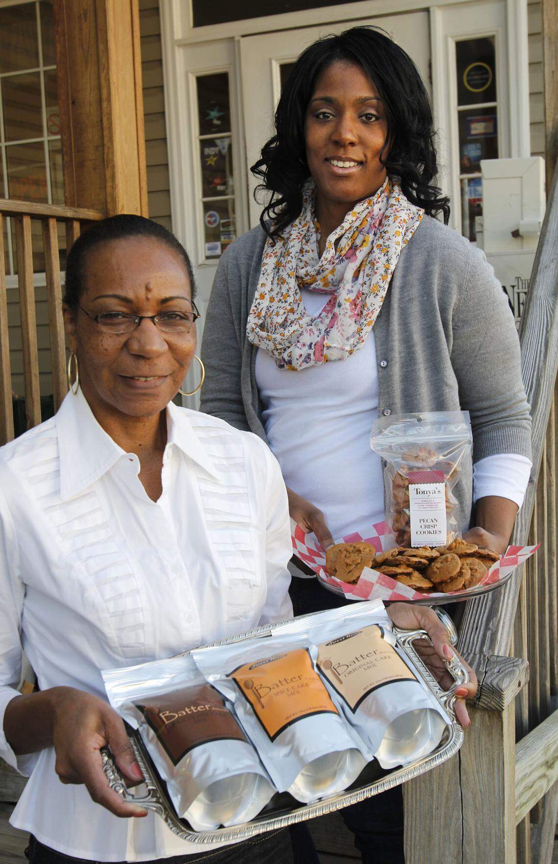 Annette Council, left, shows samples of her cake mixes, and her niece Tonya Council shows samples of her cookies in 2011. Mildred Council, Annette's mother and Tonya's grandmother, died May 20, 2018, leaving a legacy of Southern cooks and bakers behind.