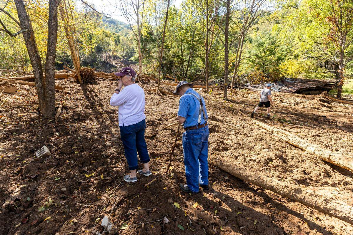 From left, Linda, Arlen and Michael Heatherly survey damage caused by a landslide on their family’s property in Cruso. The remnants of Hurricane Helene caused more than 300 landslides, many in North Carolina.