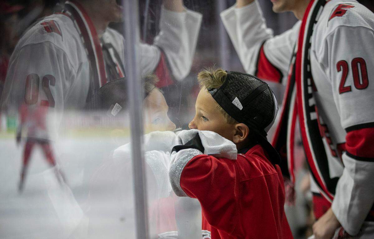 Eight-year-old Bryson Denning of Benson, N.C., leans against the glass during the fourth overtime period of the Carolina Hurricanes’ Eastern Conference Finals game agains the Florida Panthers, early on on Friday morning, May 19, 2023 at PNC Arena in Raleigh, N.C.